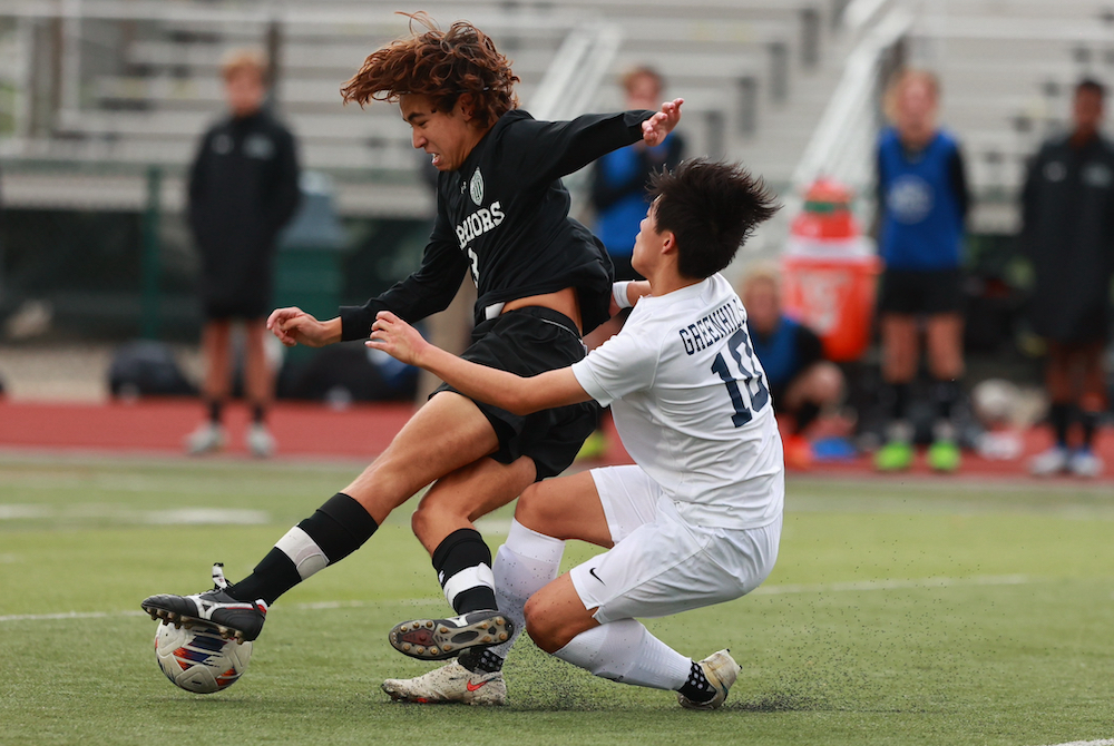 WMC’s Jake Hwang (3) works to keep possession with Greenhills’ Michael Zheng defending. 