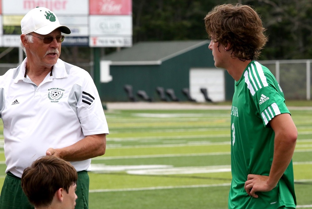 Recently-retired Alpena soccer coach Tim Storch, left, talks things over with one of his players. 