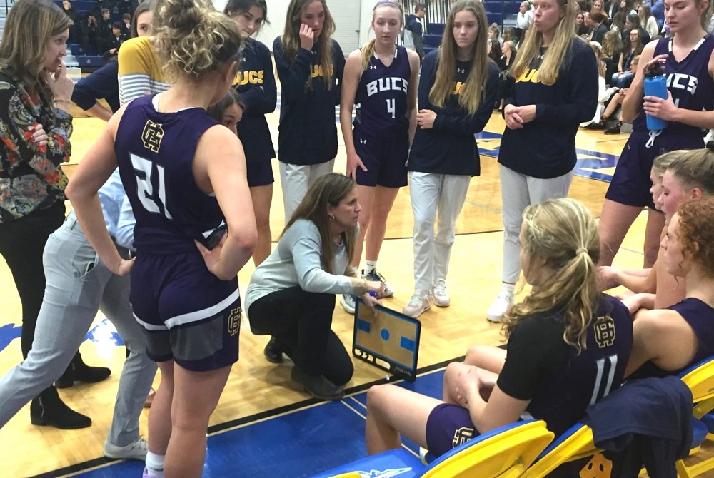 Grand Haven girls basketball coach Katie Kowalczyk-Fulmer talks things over with her team during a game earlier this decade. 