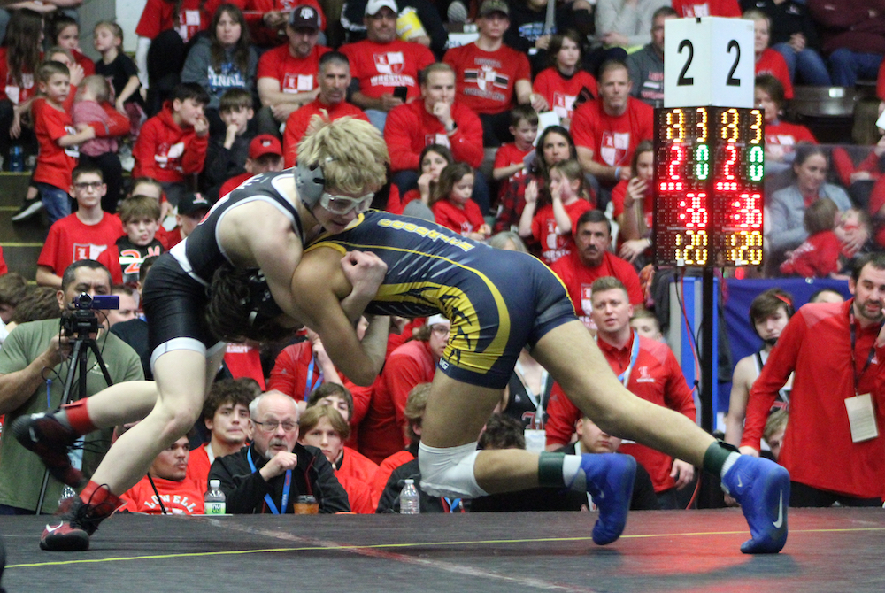 Lowell’s Carter Cichocki, left, and Goodrich’s Ethan Garza lock up at 120 pounds; Cichocki would win 2-0. 