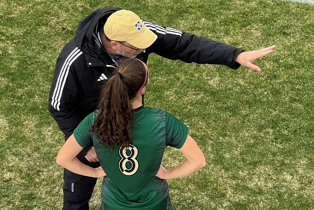 Traverse City West coach Ed Fantozzi talks things over with Raegan LaCross during a game this season. 