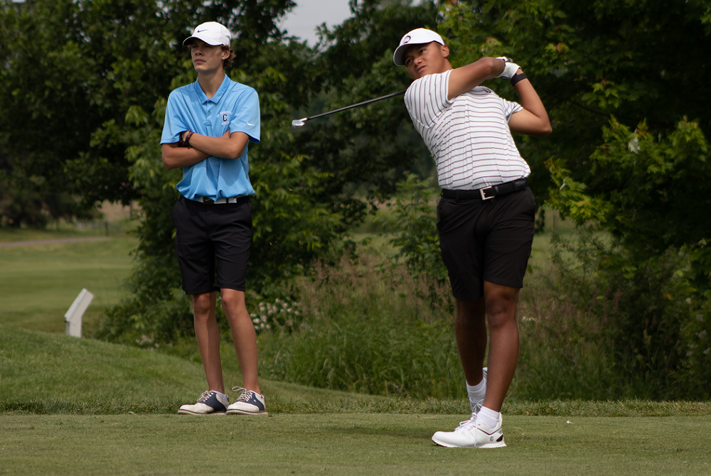 Brother Rice's Lorenzo Pinili, right, tees off during the 2022 LP Division 1 Finals as Grand Rapids Christian's Adam Workman follows his shot.