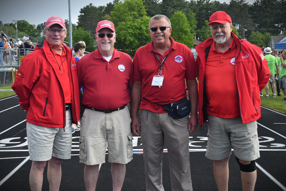 Paul Price, second from left, takes a minute for an officials photo during the 2022 Upper Peninsula Track & Field Finals at Kingsford. 