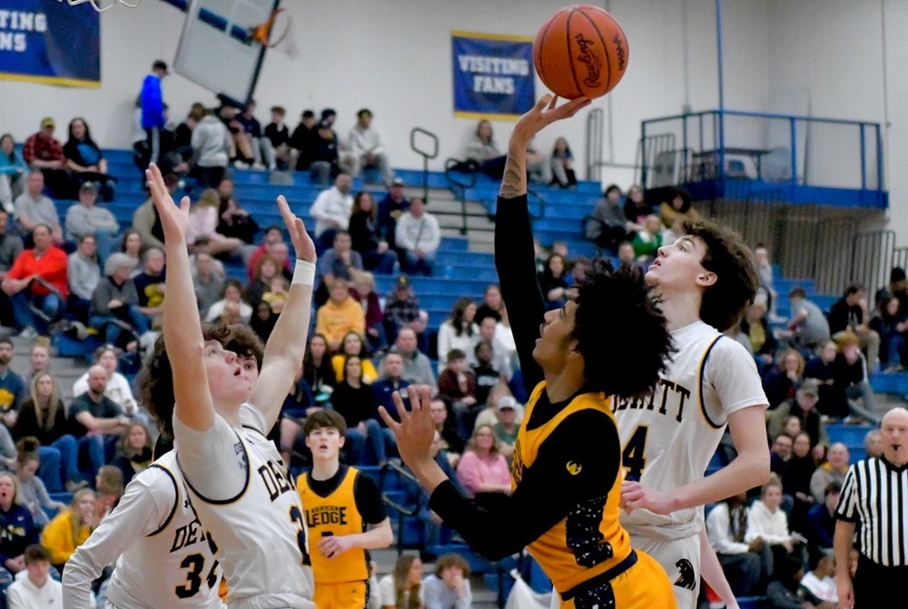 Grand Ledge and DeWitt players meet in the lane during the Panthers’ 52-35 win Friday. 