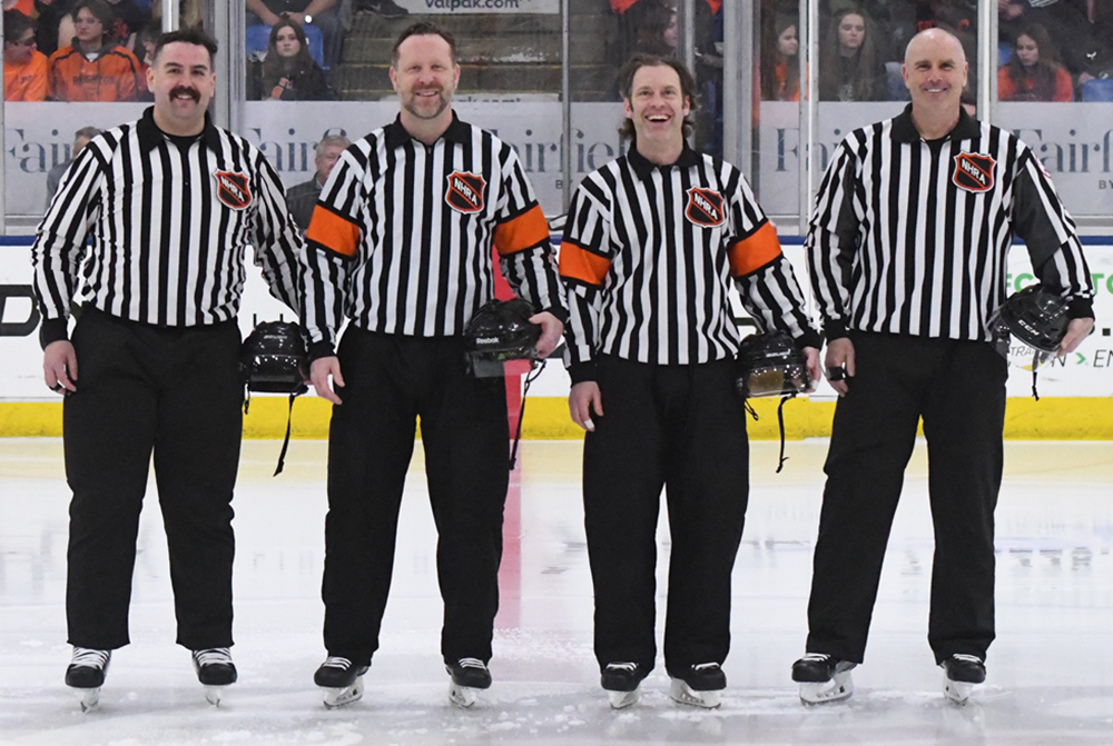 The four officials line up for a photo before the 2023 Division 1 Final.