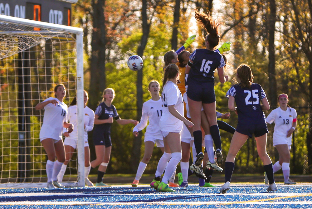 Gull Lake's Lilah Smith (16) rises above the defense to connect on a header against Portage Central.