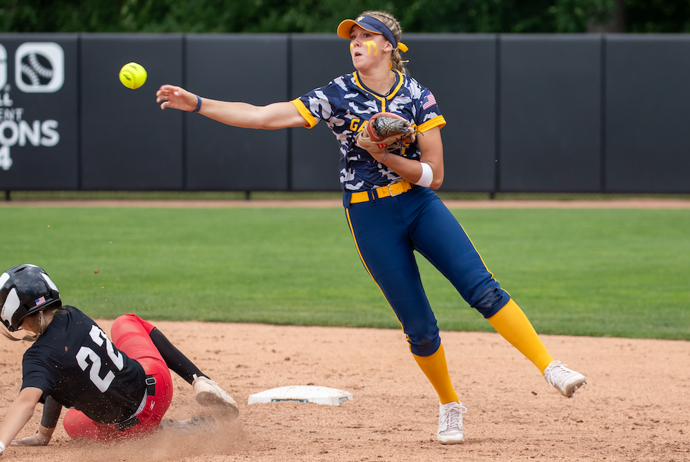 Gaylord’s Aubrey Jones throws to first Thursday as Milan’s Tierra Ronayne slides into second base. 