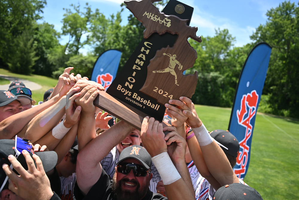 Northville hoists its championship trophy Saturday at Old College Field.