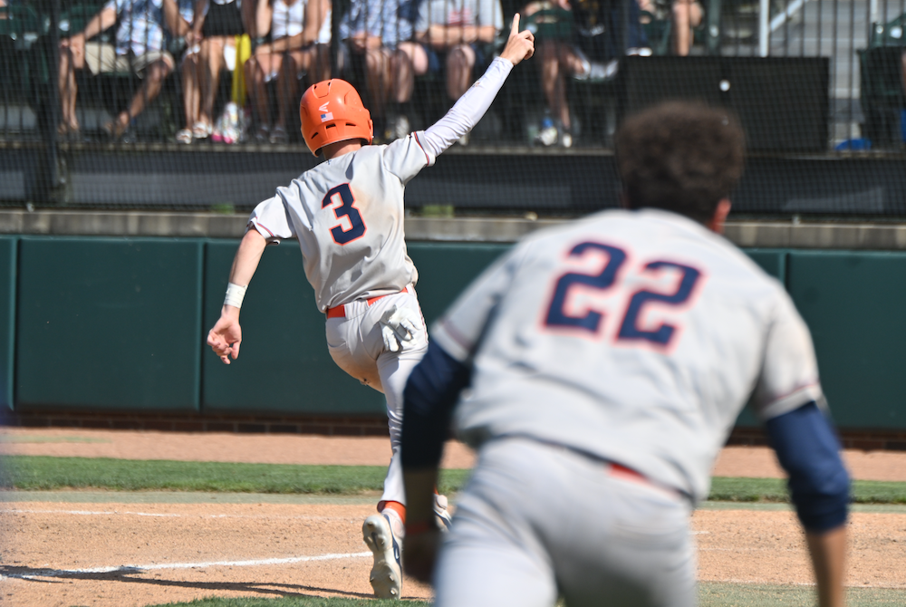 Flint Powers Catholic's Eli Sturgess crosses the plate for the winning run during his team's Semifinal victory Friday at McLane Stadium. 