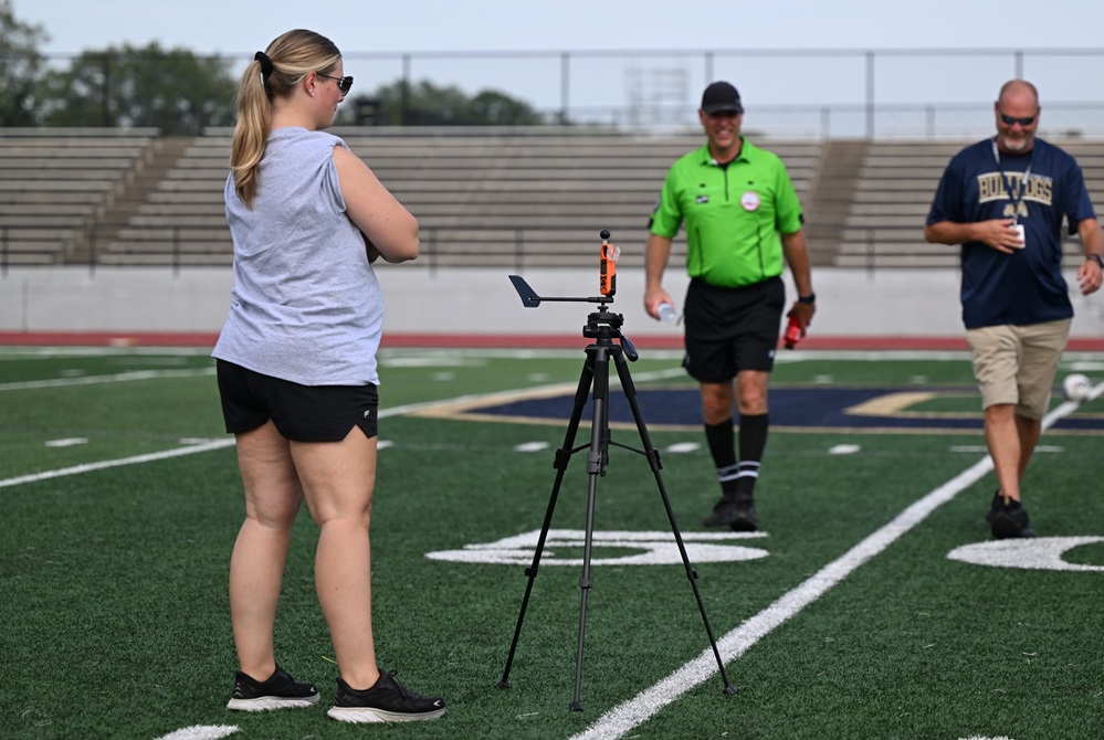 Otsego High School trainer Taylor Austin tracks field conditions Monday during a soccer match.