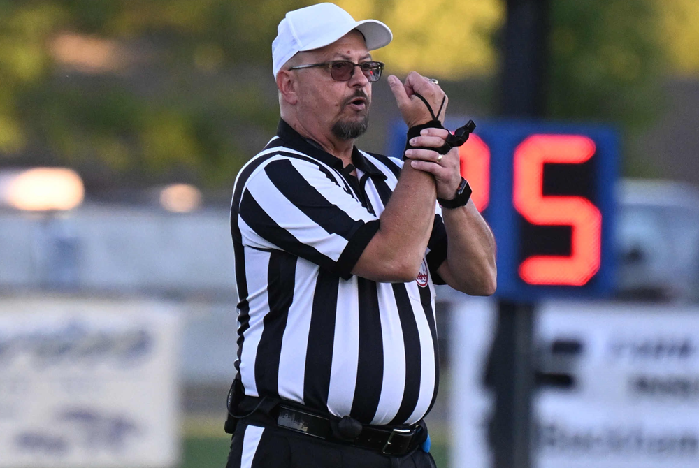 A football official signals holding during a 2023 game. 