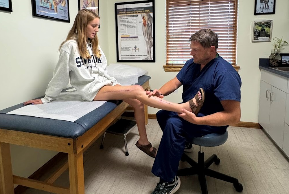 Leighton Smith, left, consults with Dr. Justin Hollander during her recovery from horse riding injuries this summer.