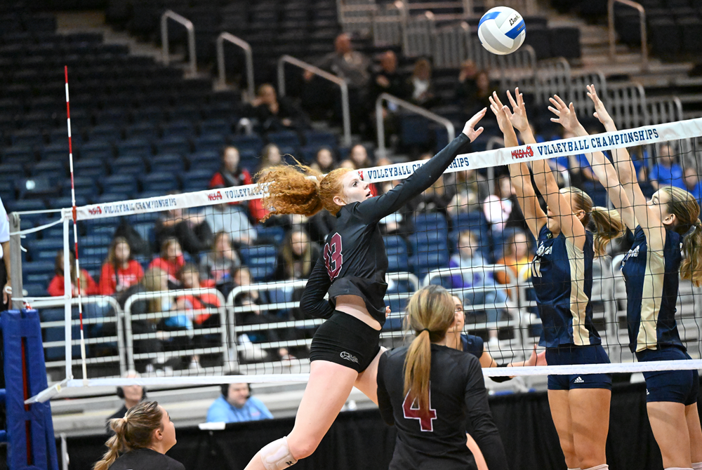 Shelby Ignash sends the ball over a block during Cass City’s Semifinal match last season against Traverse City St. Francis. 