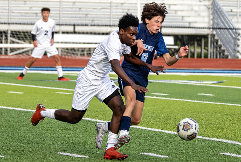 Westland John Glenn and Sterling Heights Stevenson players pursue the ball during their matchup this season. 