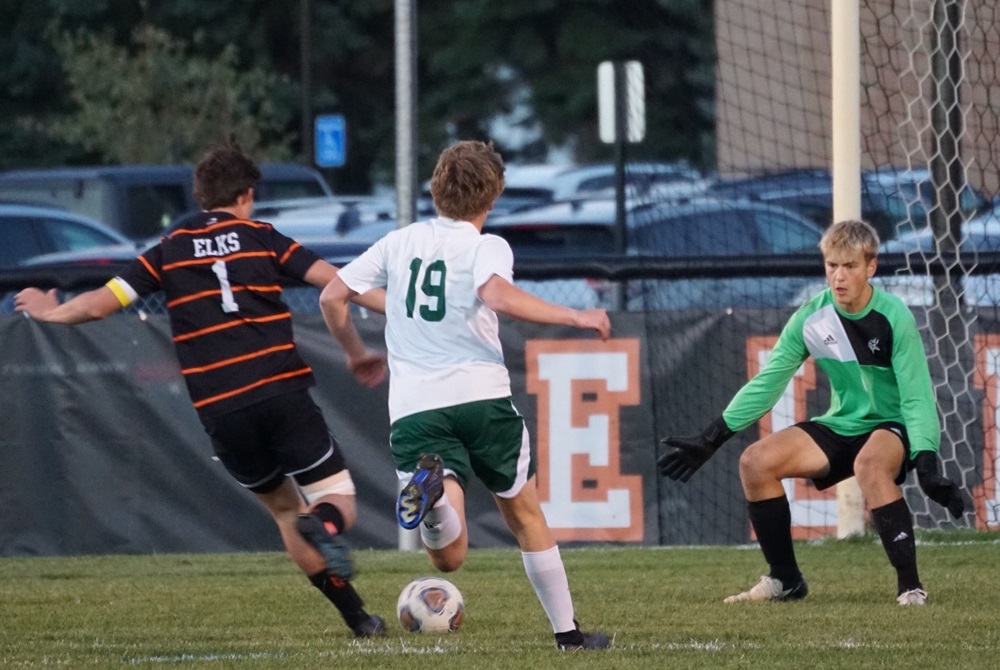 rayling keeper Jordan Peters, far right, readies to make a stop against Elk Rapids.