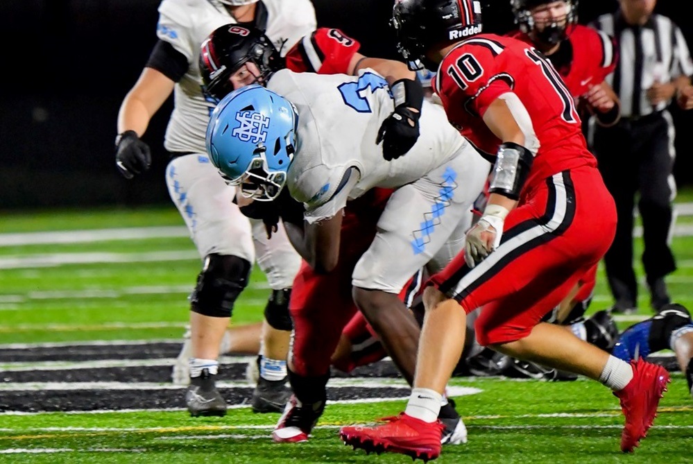 Muskegon Mona Shores' Jonathan Pittman powers into the Grand Blanc defense during his team's season-opening win.