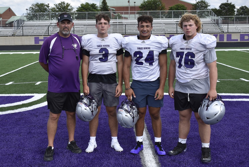 From left: Three Rivers varsity football coach Jeff Awe and players Mason Awe, Jace Gray and Sam Reynolds.