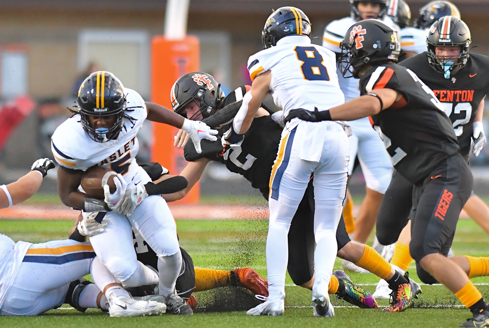 Fenton wraps up Haslett's Cornelius Walker (5) during the Tigers' 21-14 win in Week 2.