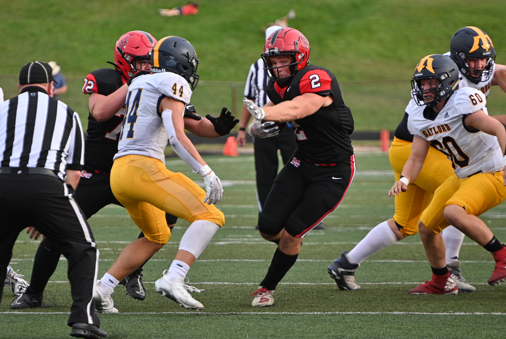 Marquette's Grant Simon (2) finds a hole to pick up several yards against Gaylord.