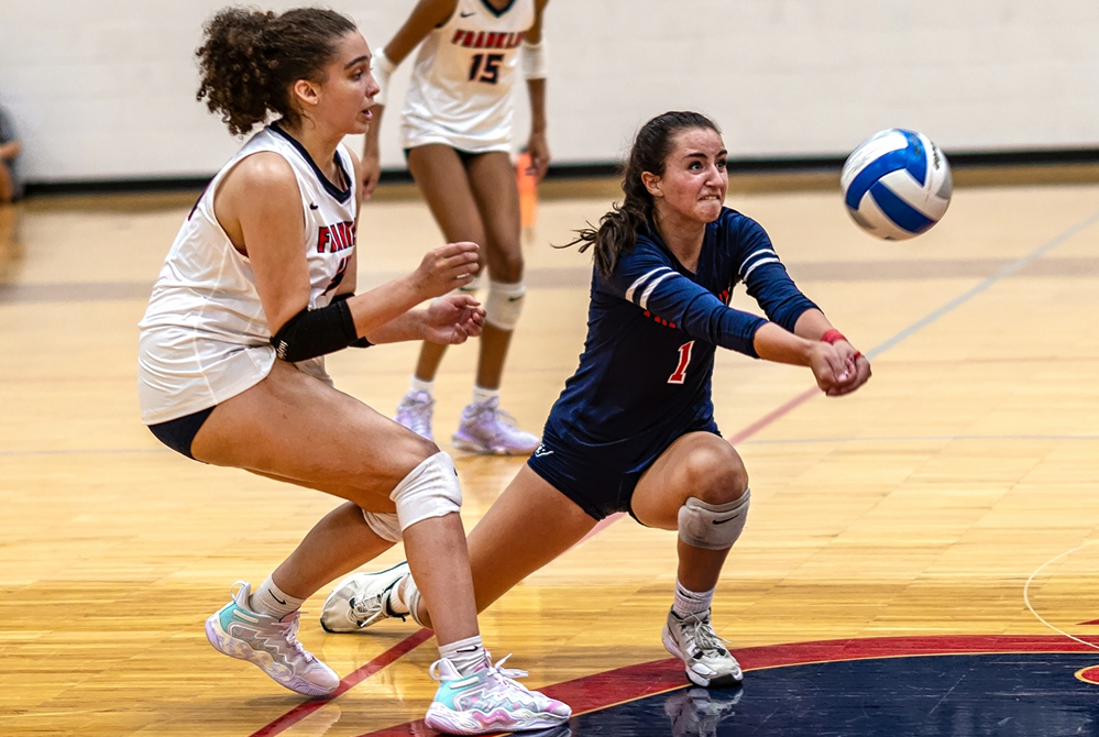 Livonia Franklin's libero (1) defends during her team's match against Livonia Churchill this season.