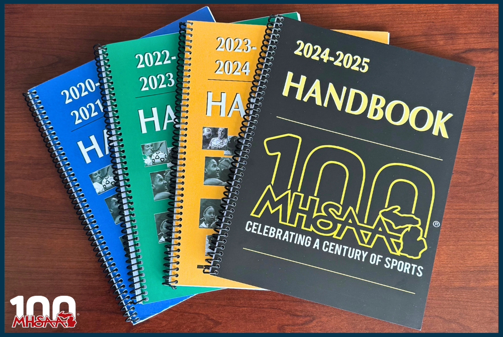 This is a stack, on a desk, of the most recent MHSAA Handbooks. 