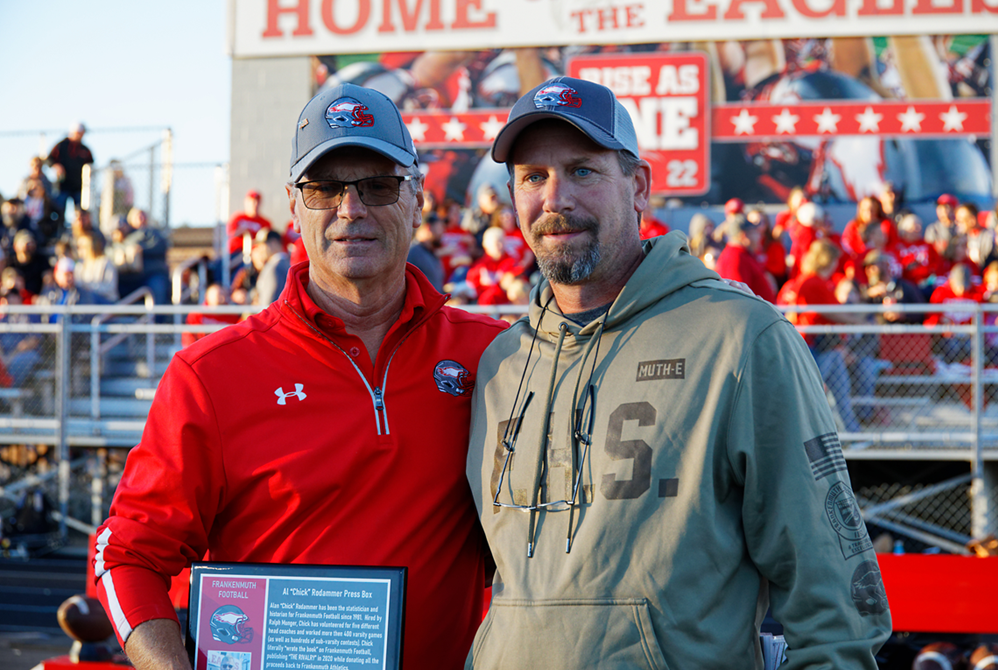 Rodammer, left and Eagles coach Phil Martin take a photo on the night the facility was named for its longtime stat person during the 2022 season.