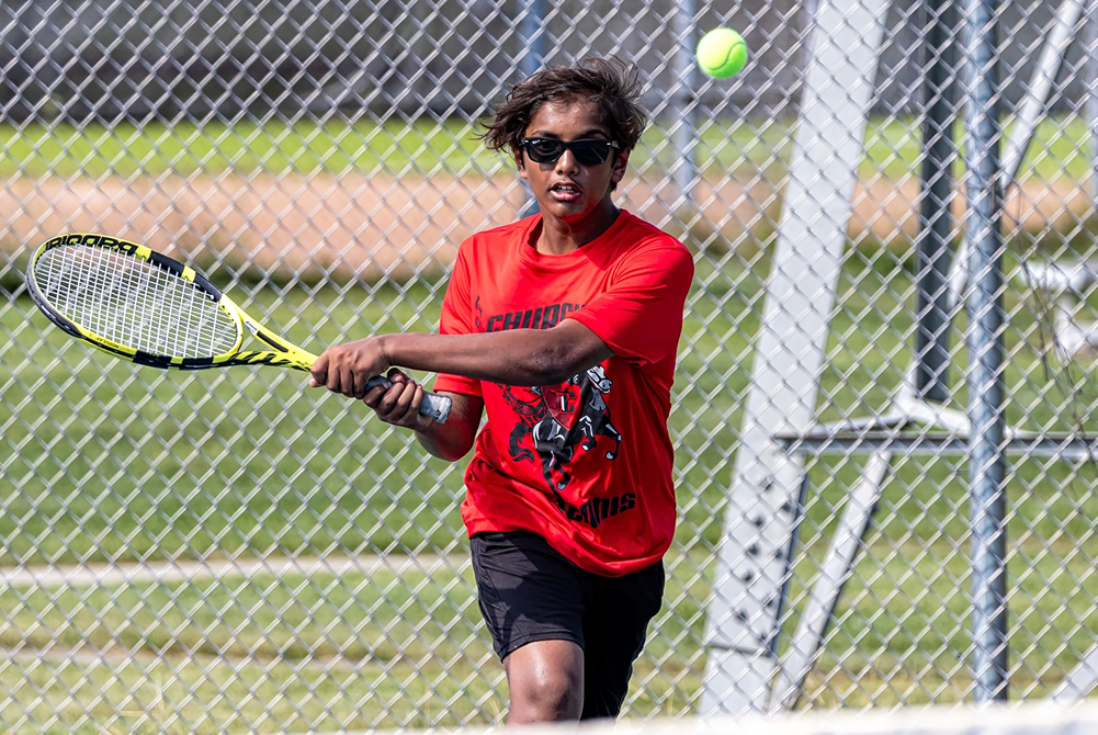 A Livonia Churchill tennis player returns a volley during a match this season.