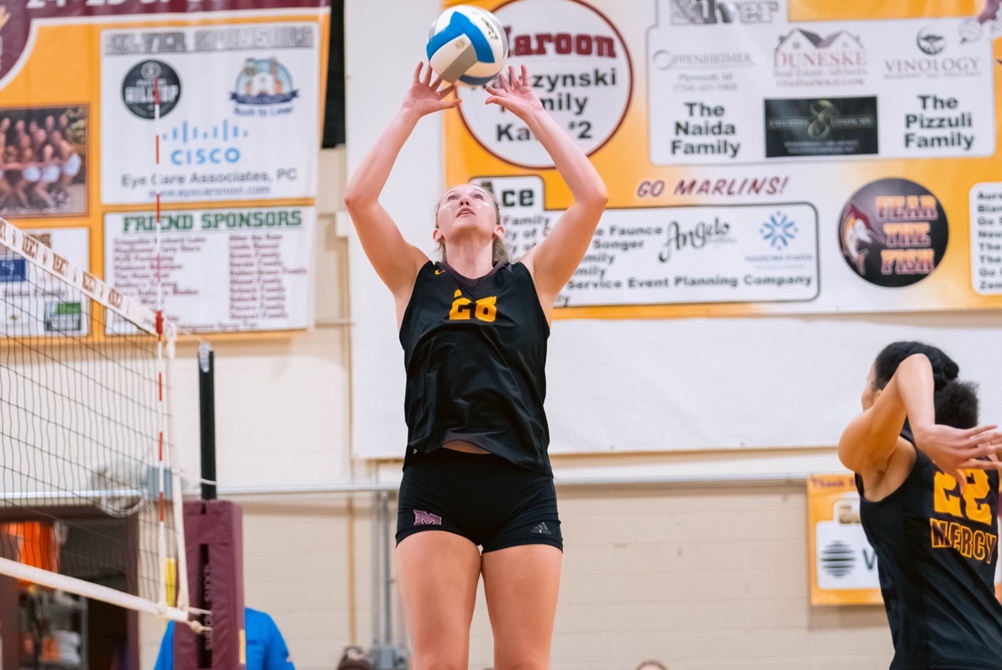 Farmington Hills Mercy's Campbell Flynn sets for a teammate during a match.