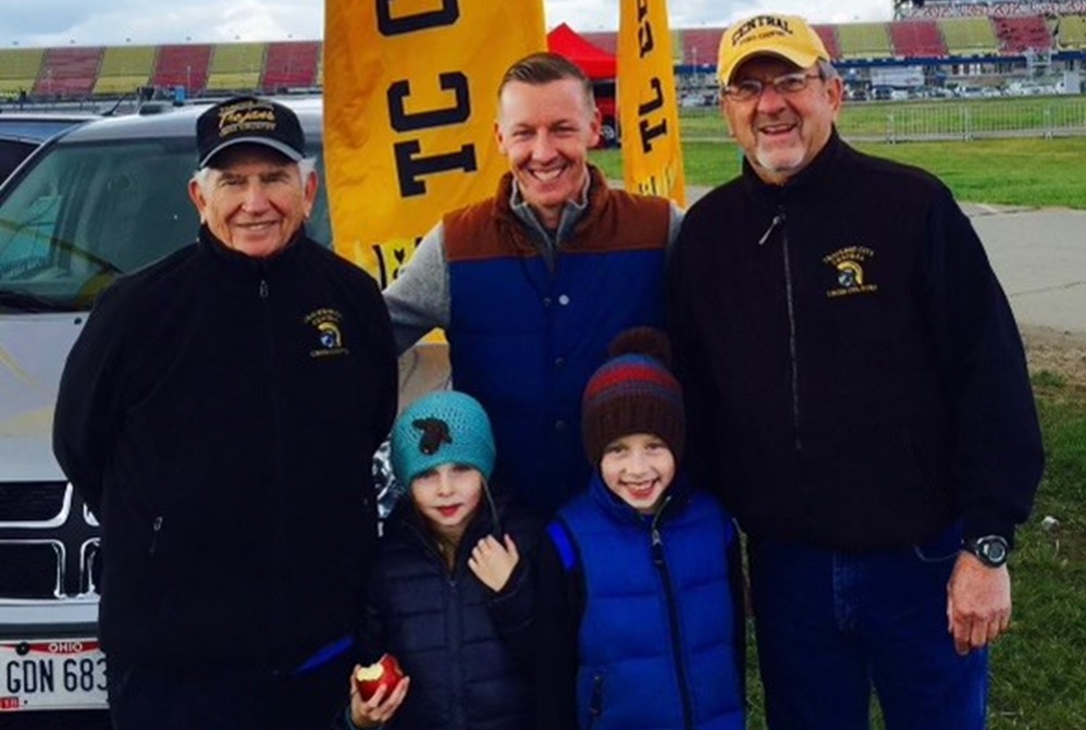 Longtime coach Don Lukens, far left, is pictured during the 2015 LP Cross Country Finals with past Traverse City Central runner John Steen (center) and Trojans coach Bob Lober, with Jane and Jack Steen standings in front. Jane and Jack Steen are current Traverse City Central runners. 