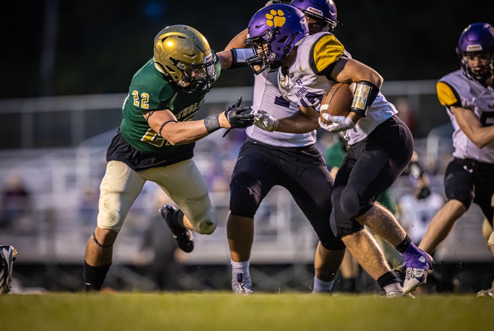 A Frankfort ball carrier and Muskegon Catholic Central defender prepare to collide near the line of scrimmage.