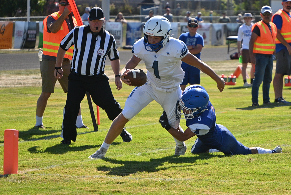 Ishpeming's Grady Gauthier holds onto Indian River Inland Lakes' quarterback Aidan Fenstermaker's leg as he gets ready to dive into the end zone during Inland Lake's Week 5 win. 