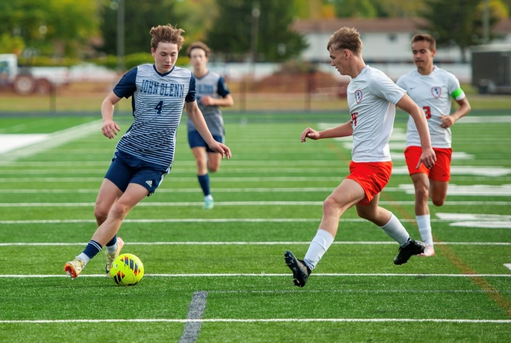 Bay City John Glenn's Asher Clark (4) possesses the ball during a match against Alma.