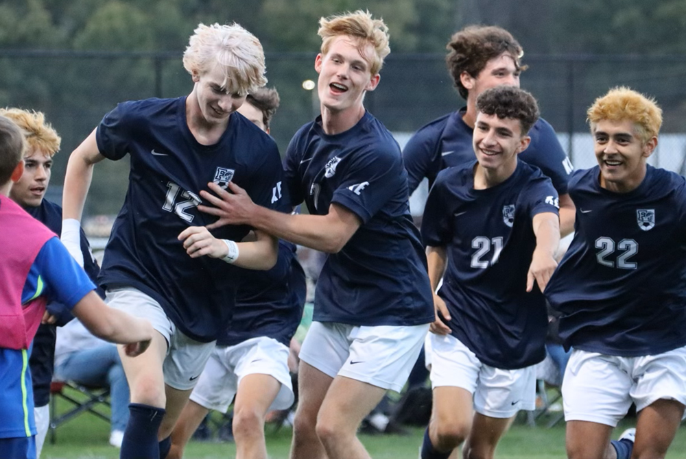 Carter Gregor (12) celebrates his goal Oct. 3 against Wyoming Godwin Heights with teammates including Isaiah Packard, Jyles Smith and Carlos Cruz.