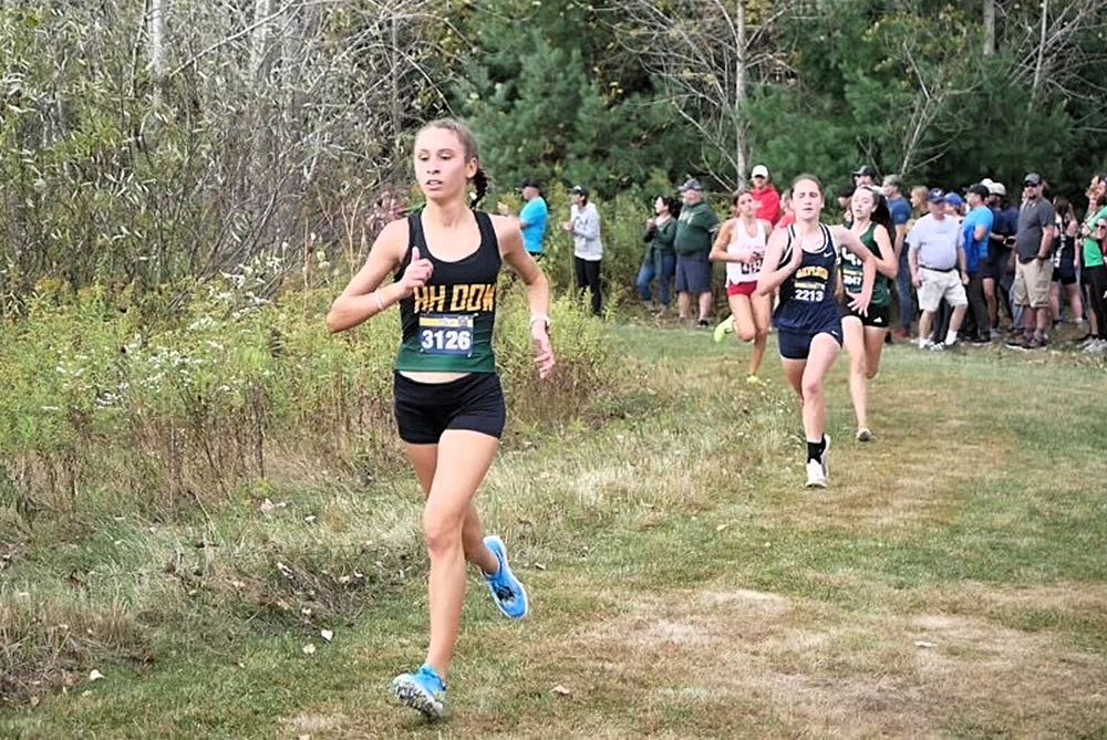 Midland Dow's Victoria Garces leads a pack through a wooded area during a race.