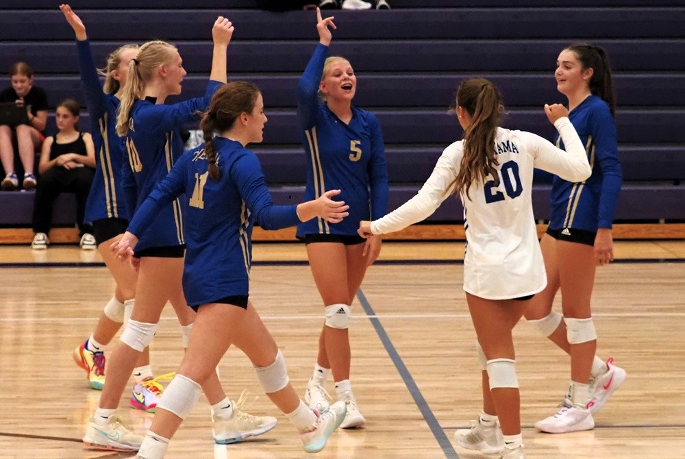 Onekama players including Elizabeth McKeough (3), Maddie Gunia (10), Hailey Hart (11) and Ava Mauntler (20) huddle during a match. 