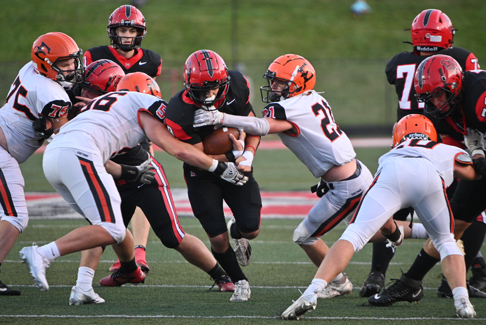 Escanaba's Alex Morgan (56) and Keagan Braun (21) converge on Marquette's Chase Niemi (9) as he gets closer to the end zone during the Sentinels' Week 6 win.