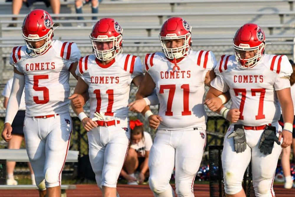 From left, Hanover-Horton’s Luke Soper (5), Jack Wooster (11), Braden Cogan (71) and Bryan Hamisfar (77) take the field together arm-in-arm.