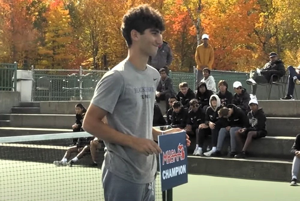 Bloomfield Hills Pierce Shaya takes a photo last season after receiving his championship medal.