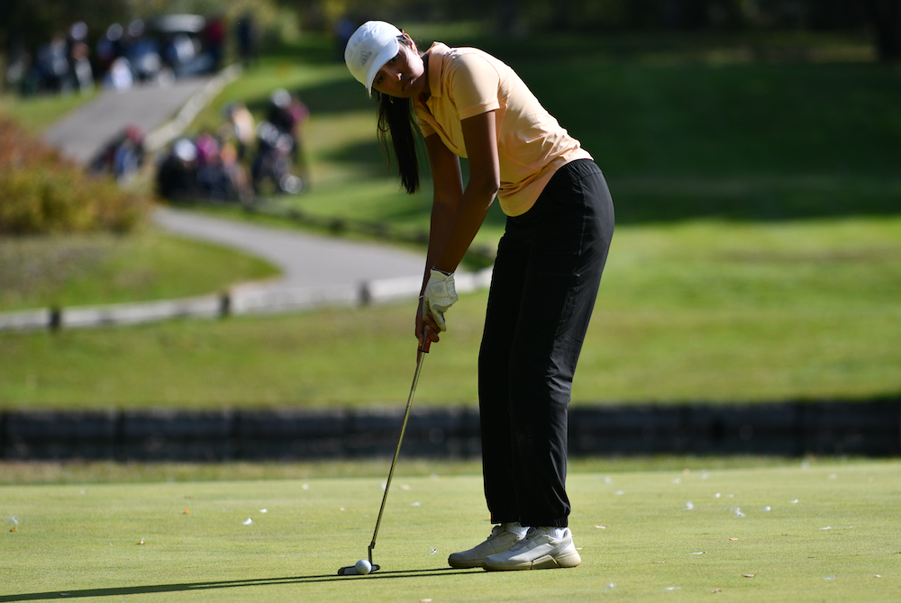 Northville’s Sanya Singhal lines up a putt during Friday’s first round at Katke at Ferris State.