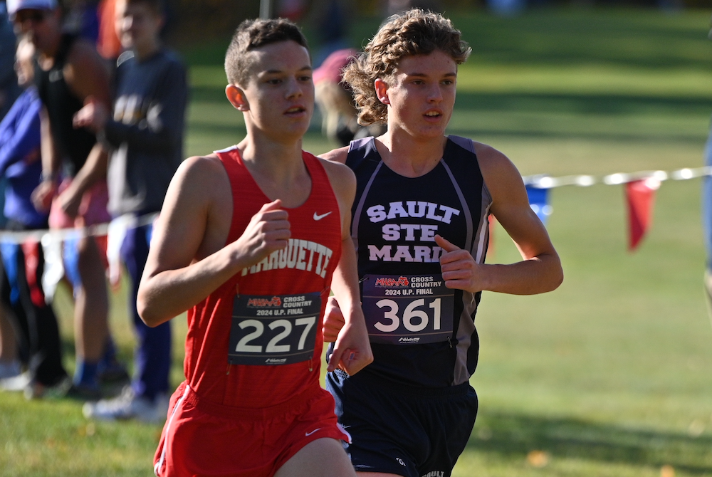 Marquette's Seppi Camilli (227) and Sault Ste. Marie's Gabe Litzner (361) run together during the Division 1 Final on Saturday.