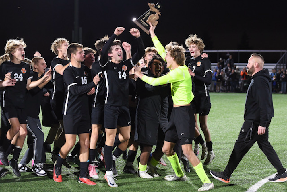 Byron Center players raise their District trophy in celebration last week. 