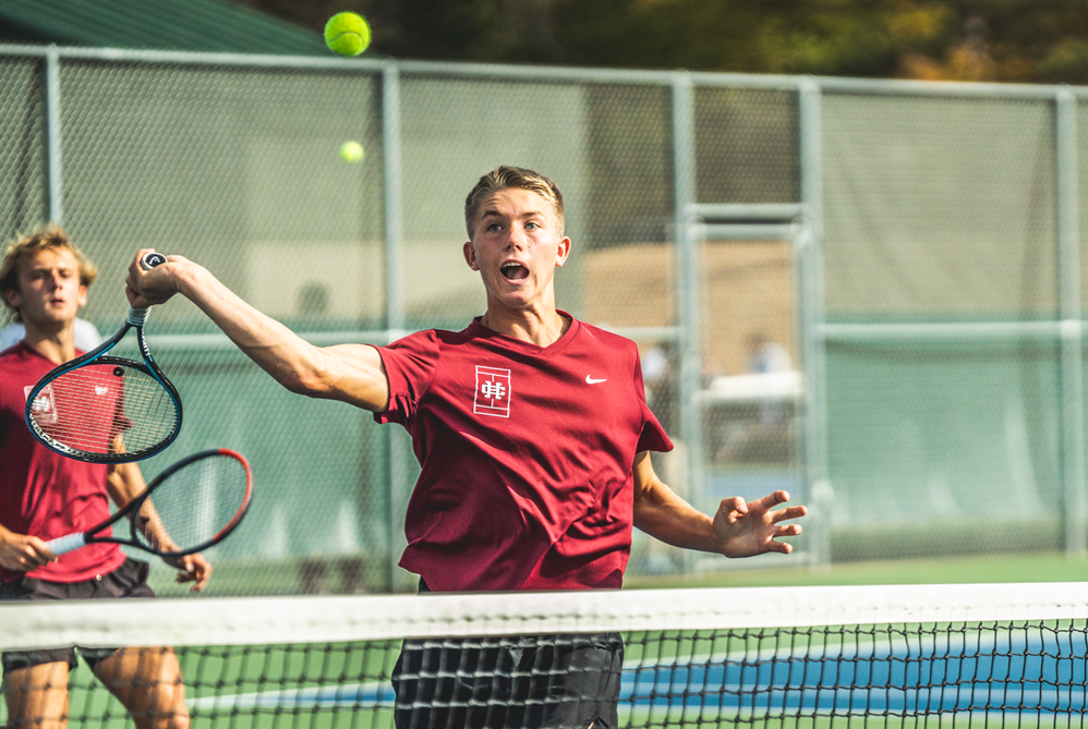 Holland Christian’s Lucas Van Wieren winds up during a No. 1 doubles match Tuesday at Midland Tennis Center. 