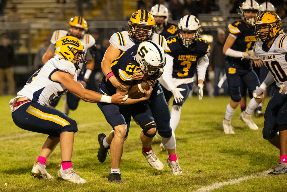 Ithaca defenders converge on a Shepherd ball carried during the Yellowjackets' 43-0 win to finish 9-0.