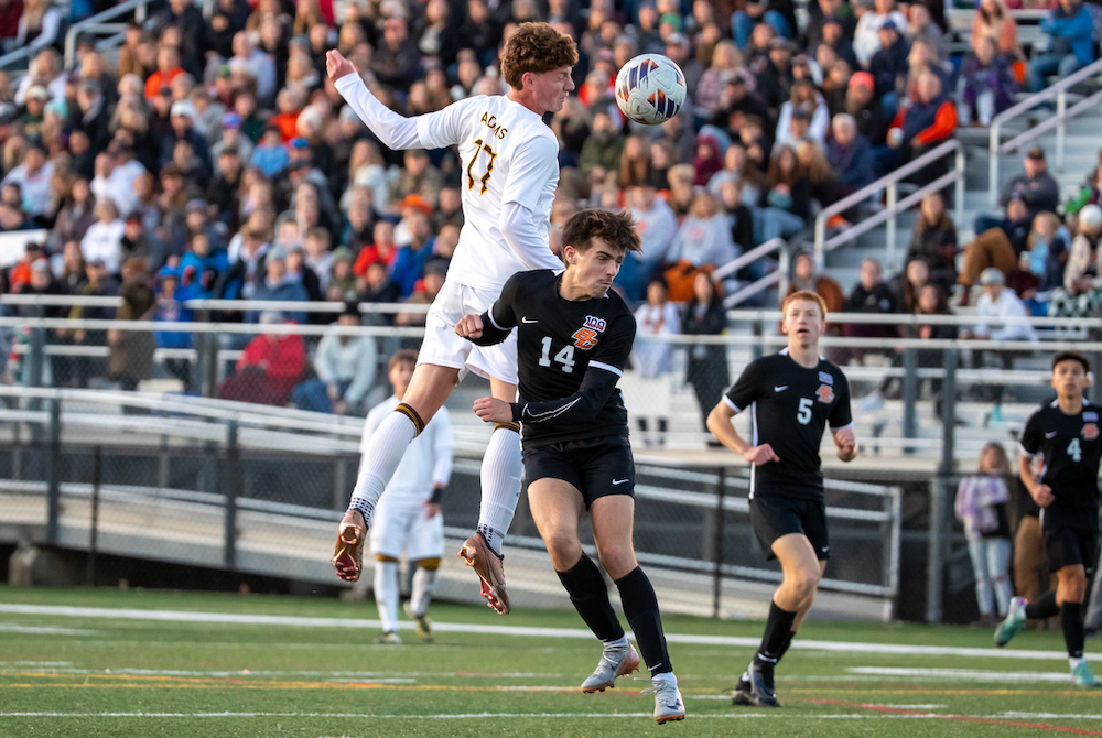 Rochester Adams’ Alex Rosin (17) and Byron Center’s Brendan Walker (14) contend for a ball during Saturday’s Division 1 Final. 