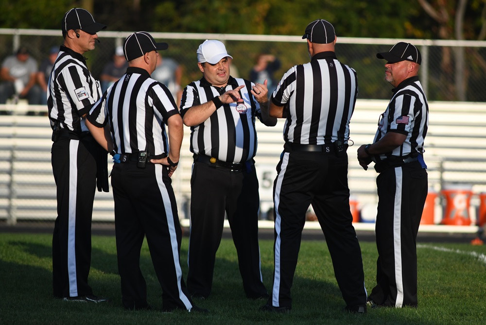 An officiating crew confers before this season’s Fowler/Bath varsity football game. 