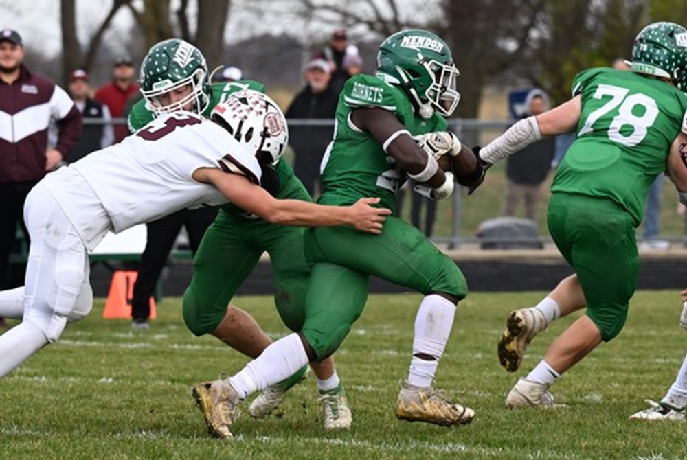 Mendon’s J.T. Lux (23) follows a blocker and pulls away from a Martin defender during his team’s Regional Final win. 