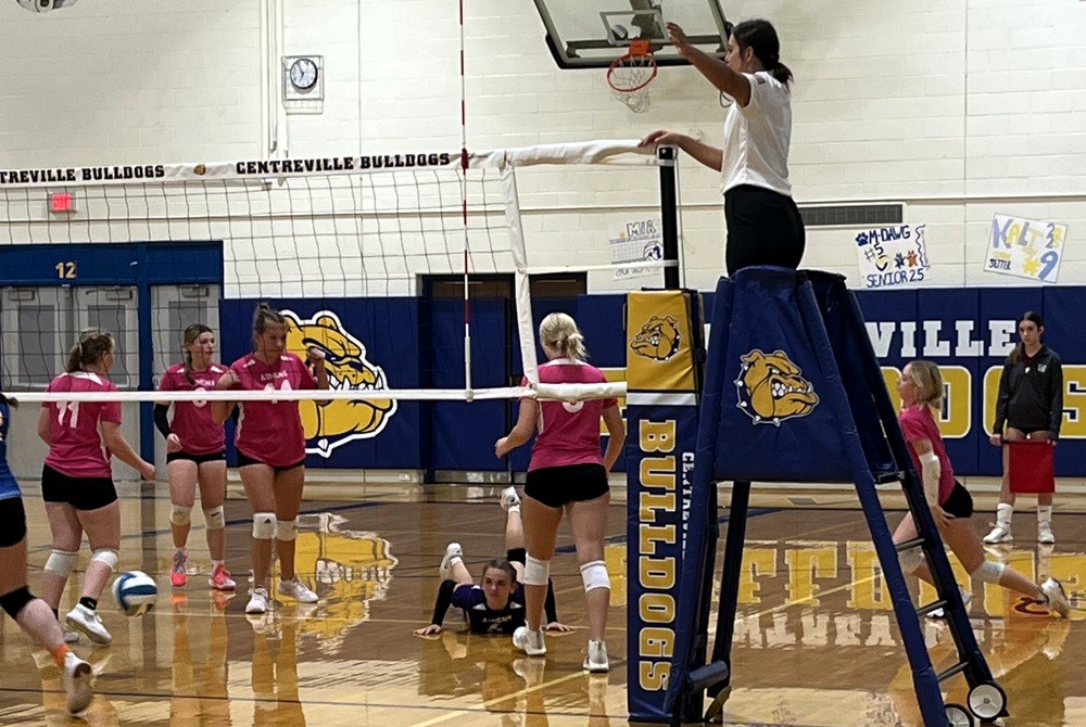 Centreville’s Mary Stears stands adjacent and above the net as she officiates a match this fall.