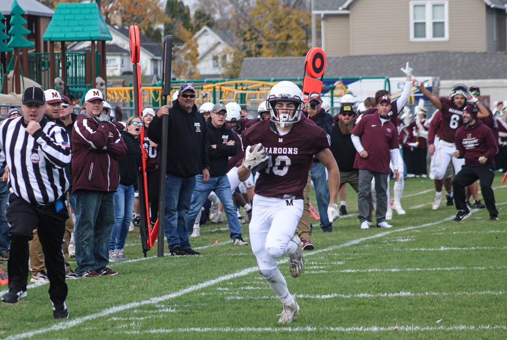 Menominee junior Landen Daigneau returns an interception for a touchdown during Saturday’s District championship game against Traverse City St Francis. 