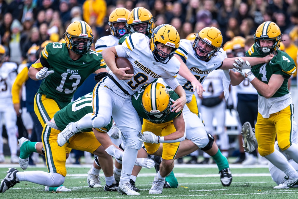 Hudsonville’s Bryce Fox (9) emerges from the grasp of multiple Howell defenders Saturday.