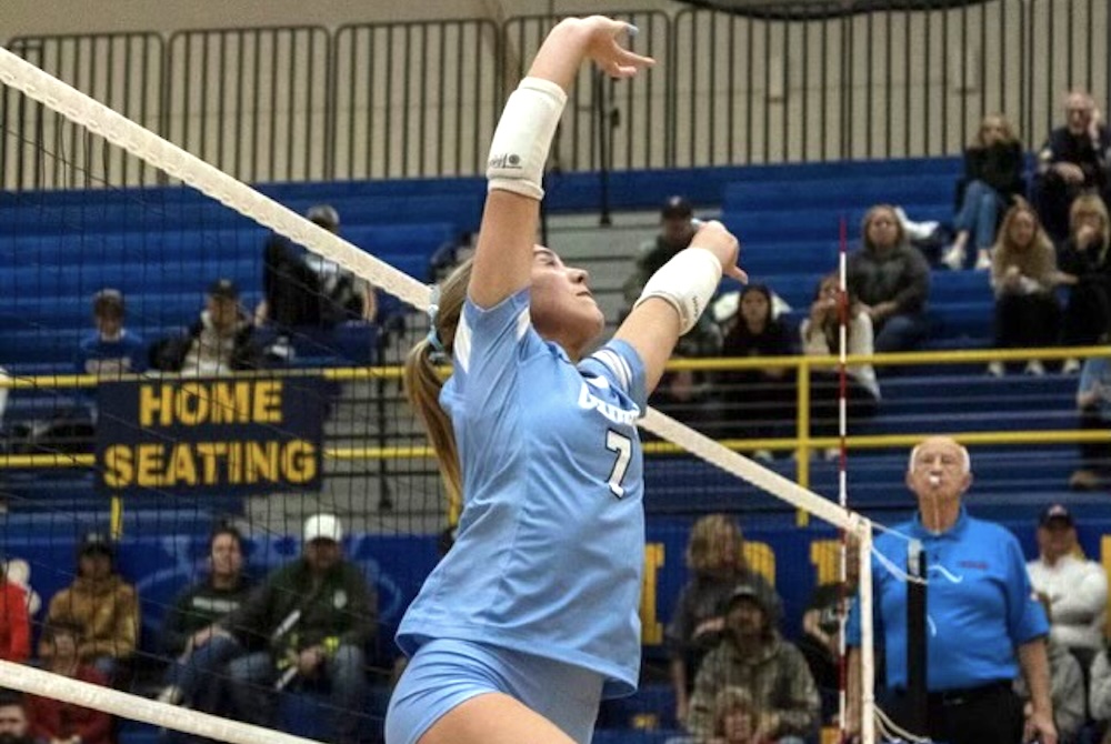 Essexville Garber setter Ella Kokaly sets a ball to a teammate during a volleyball match.